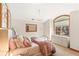 Cozy bedroom with a large arched window and a decorative chandelier, creating a warm and inviting space at 2411 S Garfield St, Denver, CO 80210