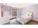 A bedroom with a bed, dresser, light-purple painted walls, and elegant chandelier at 2411 S Garfield St, Denver, CO 80210