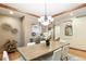 Dining room with custom wood trim, hardwood floors, a stylish chandelier, and elegant artwork at 2411 S Garfield St, Denver, CO 80210