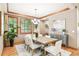 Cozy dining room with decorative chandelier, hardwood floors, and neutral colored walls at 2411 S Garfield St, Denver, CO 80210