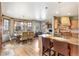 Open dining room featuring hardwood floors, a chandelier, and large windows providing ample natural light at 2411 S Garfield St, Denver, CO 80210