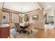 Traditional dining room features wood trim, a decorative rug, and abundant natural light from multiple windows at 2411 S Garfield St, Denver, CO 80210