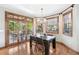 Well-lit dining room with outdoor views, hardwood floors, and modern lighting fixtures at 2411 S Garfield St, Denver, CO 80210