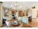 Dining area with decorative lighting and a seamless transition to the kitchen, complete with a built-in workstation at 2411 S Garfield St, Denver, CO 80210