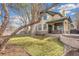 Beautiful home exterior with a well-manicured lawn, stone accents, and a cozy covered patio area at 2411 S Garfield St, Denver, CO 80210