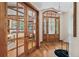 Inviting foyer with hardwood floors, elegant chandelier, and view of the office through glass French doors at 2411 S Garfield St, Denver, CO 80210