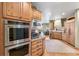 Updated kitchen with wooden cabinetry, granite countertops, and stainless steel appliances at 2411 S Garfield St, Denver, CO 80210