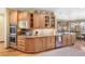 Modern kitchen with wood cabinetry, granite countertops, and stainless steel appliances at 2411 S Garfield St, Denver, CO 80210