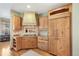 Spacious kitchen boasts wooden cabinets, granite countertops, and stainless steel appliances at 2411 S Garfield St, Denver, CO 80210