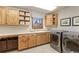 Laundry room with wooden cabinets, counter space, utility sink and side-by-side washer and dryer at 2411 S Garfield St, Denver, CO 80210