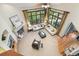 Sunlit living room with high ceilings, fireplace, and large windows offering scenic views at 2411 S Garfield St, Denver, CO 80210