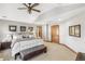 Large main bedroom with vaulted ceiling, bench seat, and ensuite bathroom entrance at 2411 S Garfield St, Denver, CO 80210