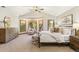 This spacious main bedroom features a vaulted ceiling, many windows, and ample furniture at 2411 S Garfield St, Denver, CO 80210
