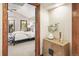 A partial view of the main bedroom featuring a bed, windows, and stylish decor at 2411 S Garfield St, Denver, CO 80210