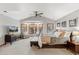 Spacious main bedroom with large windows, seating area, and ceiling fan at 2411 S Garfield St, Denver, CO 80210
