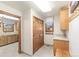 Mudroom featuring wood cabinets, a built-in bench, hooks, and tile floors at 2411 S Garfield St, Denver, CO 80210
