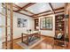 Bright office with custom built-ins, tray ceilings, hardwood flooring, and a large window at 2411 S Garfield St, Denver, CO 80210