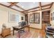 Well-lit home office with custom wood shelving, tray ceiling, and a large window overlooking the yard at 2411 S Garfield St, Denver, CO 80210
