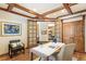 Charming office featuring custom ceiling beams, hardwood floors, and stylish decor at 2411 S Garfield St, Denver, CO 80210