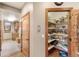 Walk-in pantry with custom shelving, wood floors, and door to adjacent hallway at 2411 S Garfield St, Denver, CO 80210