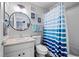 Clean bathroom with a modern mirror, vanity, and bathtub with a stylish shower curtain at 23500 E Alamo Pl # B19, Aurora, CO 80016