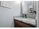 Close up of a well-lit bathroom with granite countertop and a decorative framed mirror at 23500 E Alamo Pl # B19, Aurora, CO 80016