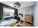 Charming bedroom with modern fan and fixtures, bright window, and wood-look flooring at 23500 E Alamo Pl # B19, Aurora, CO 80016