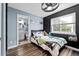 Cozy bedroom with ensuite bathroom, wood-look flooring, and good natural light at 23500 E Alamo Pl # B19, Aurora, CO 80016