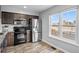 Beautiful kitchen features stainless appliances, granite countertops, and lovely wood-look flooring at 23500 E Alamo Pl # B19, Aurora, CO 80016