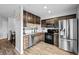 Spacious kitchen with stainless steel appliances, granite countertops, and warm wood-look floors at 23500 E Alamo Pl # B19, Aurora, CO 80016