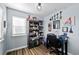 The well-lit office features a large window, wood-look floors, and playful decor at 23500 E Alamo Pl # B19, Aurora, CO 80016