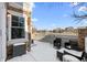 A cozy snow-covered patio offers outdoor seating, perfect for relaxing with a view of the neighborhood at 23500 E Alamo Pl # B19, Aurora, CO 80016