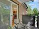 A cozy balcony overlooking the complex exterior featuring a chair, small table and view into kitchen at 1201 Race St # 10, Denver, CO 80206