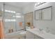 Bright bathroom featuring a shower-tub combo, updated vanity, and modern fixtures at 1201 Race St # 10, Denver, CO 80206