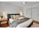 Comfortable bedroom featuring warm lighting, plush bedding, and ample closet space at 1201 Race St # 10, Denver, CO 80206
