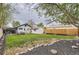 Green backyard with privacy fence, garden beds, patio furniture, and detached garage at 3930 S Sherman St, Englewood, CO 80113