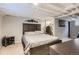 Basement bedroom with wood-paneled accent wall, updated carpet, and walk-in closet at 3930 S Sherman St, Englewood, CO 80113