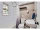 Cozy bathroom features white subway tile, a shower-tub combo, and a unique stained glass window at 3930 S Sherman St, Englewood, CO 80113