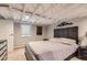 View of bedroom with carpet flooring, mountain art, and wood-slat accent headboard at 3930 S Sherman St, Englewood, CO 80113