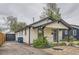 View of home's side featuring a detached garage, driveway, and low maintenance landscaping at 3930 S Sherman St, Englewood, CO 80113