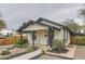 Charming home with a covered porch, gray trim, gravel landscaping, and a walkway leading to the front door at 3930 S Sherman St, Englewood, CO 80113