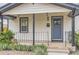 Home's front door featuring dark trim, modern exterior lighting, and well maintained landscaping at 3930 S Sherman St, Englewood, CO 80113