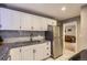 Kitchen showcasing white cabinets, stainless steel appliances, and tiled backsplash at 3930 S Sherman St, Englewood, CO 80113