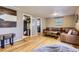 Spacious living room with hardwood floors, comfortable seating, and a view into other rooms at 3930 S Sherman St, Englewood, CO 80113