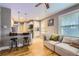 Open-concept living room featuring hardwood floors, natural light, sofa, and view to the kitchen at 3930 S Sherman St, Englewood, CO 80113