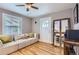 Cozy living room featuring hardwood floors, neutral walls, and a large comfortable sofa at 3930 S Sherman St, Englewood, CO 80113
