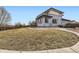 This backyard boasts a large yard, concrete patio, and lush landscaping, ideal for outdoor enjoyment at 10910 Touchstone Loop, Parker, CO 80134