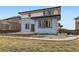 The back of this house has a well-manicured lawn, stone accents, and a patio area at 10910 Touchstone Loop, Parker, CO 80134