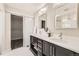 Bathroom with dual vanities, modern lighting, and a walk-in closet with sliding door at 10910 Touchstone Loop, Parker, CO 80134