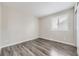 Empty bedroom with hardwood floors, plantation shutters, and plenty of natural light at 10910 Touchstone Loop, Parker, CO 80134